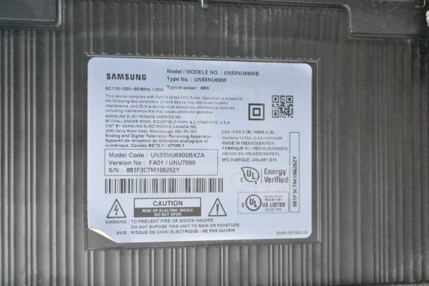 Label of Samsung UN55NU6900B 55" TV showing model code, voltage, and energy certification. Buyer must pick up.