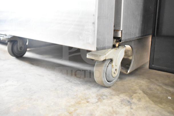 Late model JBT 2ND-GEN-MFJ-HE Citrus Juicer on sturdy commercial casters, designed for mobility and durability.