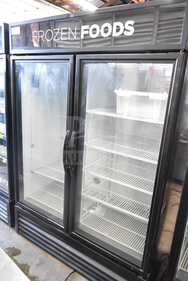 2019 True GDM-49F-HC 2 Door Reach In Freezer Merchandiser, black exterior, "Frozen Foods" sign, excellent condition.