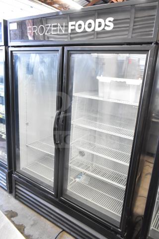 2019 True GDM-49F-HC 2 Door Reach In Freezer Merchandiser, black exterior, "Frozen Foods" sign, excellent condition.