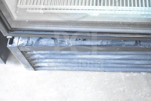 2019 True GDM-49-HC commercial freezer base. Slight dust visible; two-door design, glass panels, 115 volts, 1 phase.