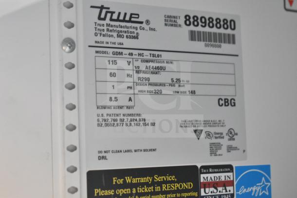 2016 True GDM-49-HC commercial cooler label showing model, voltage, compressor specs, refrigerant type, and serial number.