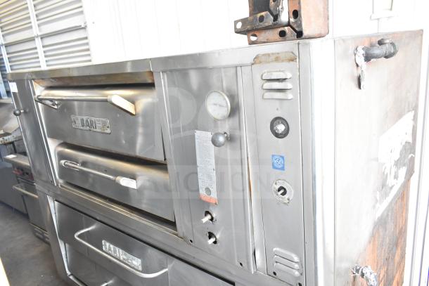 2 Bari M354 commercial single deck pizza ovens, natural gas powered, stainless steel, used condition, visible dials and labels.