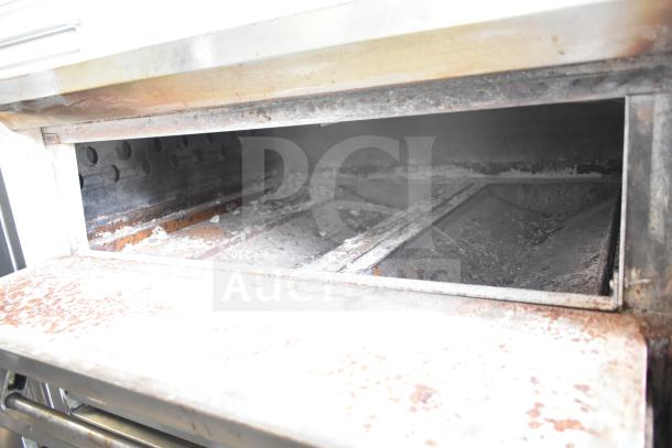 2 Bari M354 commercial natural gas pizza ovens, single deck, used condition, visible wear inside, stainless steel exterior.