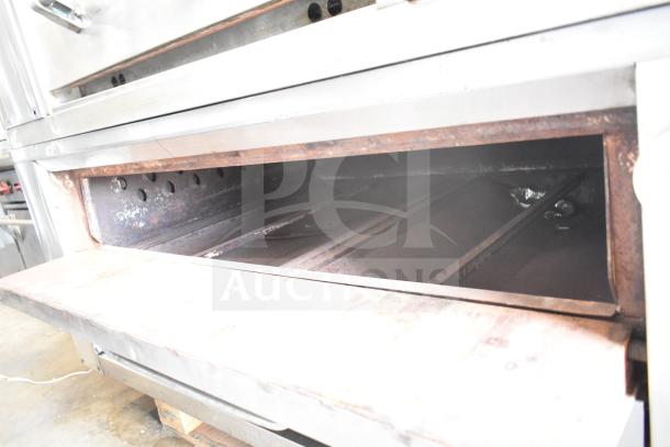 2 Bari M354 commercial pizza ovens, single deck, natural gas powered, stainless steel, used condition, visible wear.