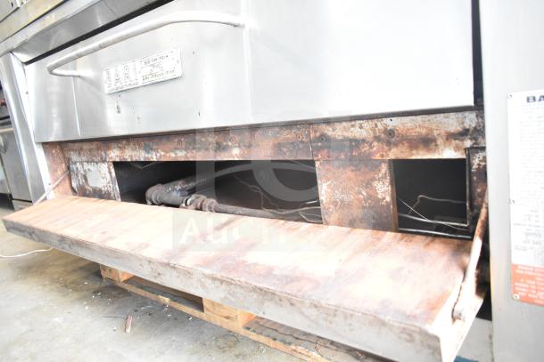 Bari M354 commercial natural gas single deck pizza ovens, metal exterior, visible wear, brand and model plaques noted.