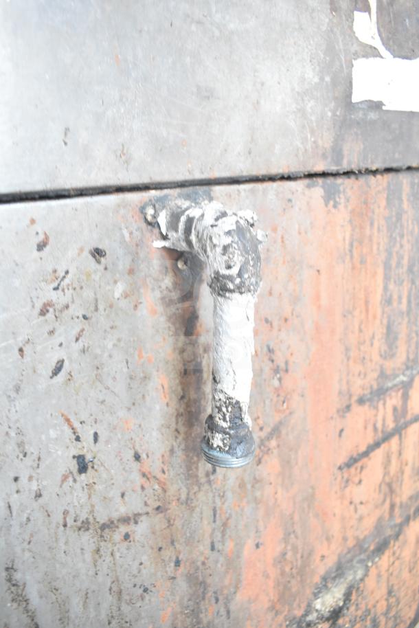 Bari M354 commercial pizza oven exterior; worn surface with visible rust and a painted pipe fitting.