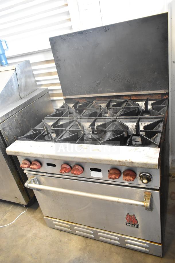 Wolf CHSSR-6-29 commercial 6-burner gas range with oven and backsplash, features red knobs, in used condition.