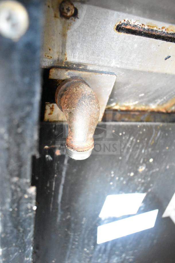 Wolf CHSSR-6-29 gas-powered 6-burner range with oven. Visible wear; features rust, indicative of use. Includes backsplash.