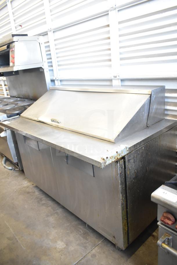 True TSSU-60-24M-B Commercial Sandwich Salad Prep Table in stainless steel with visible wear, 115V, on casters.