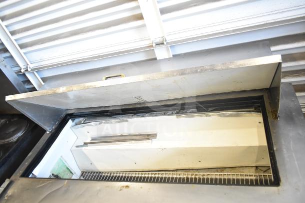 True TSSU-60-24M-B sandwich salad prep table, open lid, stainless steel, minor wear, on commercial casters, 115V.