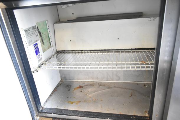 True TSSU-60-24M-B Sandwich Salad Prep Table, commercial casters, Bain Marie mega top, 115 volts, showing interior shelf and condition.