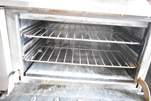 Vulcan ESB60 commercial electric hot plate range oven interior, features dual racks, signs of wear, 208V, 3 phase.