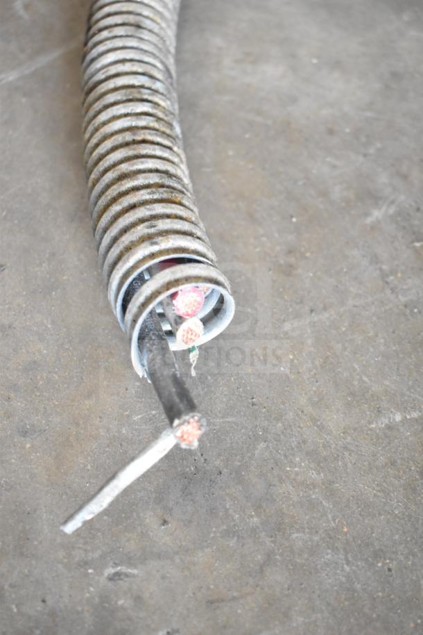 Close-up of frayed electrical cable, possibly from Vulcan ESB60 commercial range. Shows exposed wires and metal coil.