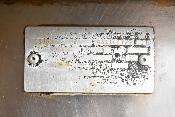 Metallic label reads "ESB60," "208 Volts," and other serial markings for Vulcan ESB60 commercial range. Signs of wear visible.