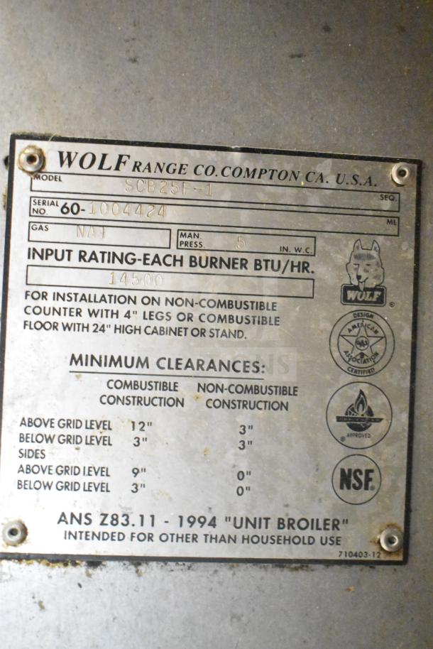 Wolf SCB25F-1 commercial natural gas charbroiler grill, missing grates. Label shows input rating 14500 BTU/hr. Model and safety info included.