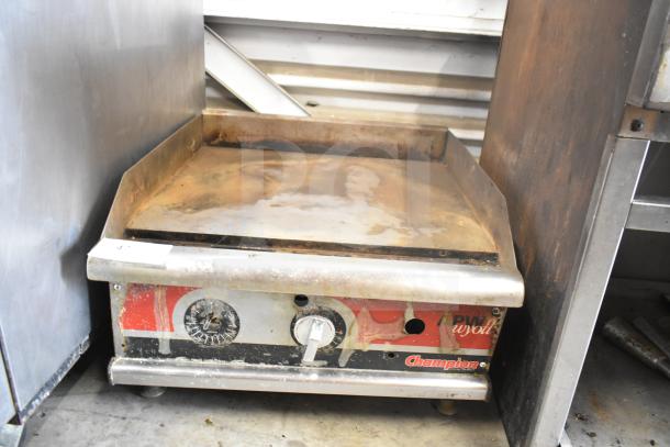 APW Wyott Champion commercial gas griddle with rust and wear, countertop model, temperature controls visible.