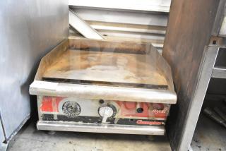 APW Wyott Champion commercial gas griddle with rust and wear, countertop model, temperature controls visible.