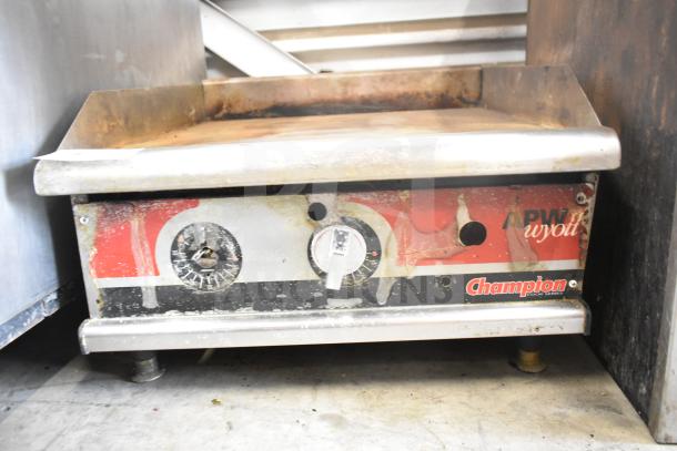APW Wyott Champion commercial gas griddle. Visible wear, rust on dials. Brand and model labels intact. Countertop format.