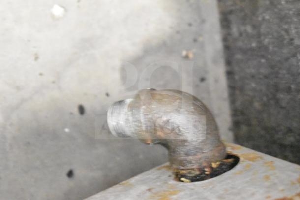 Rusty metal pipe close-up, likely part of the APW Wyott Champion Commercial Gas Flat Top Griddle. Condition shows wear.