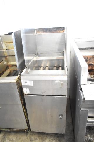 Commercial gas powered deep fat fryer, stainless steel finish, visible signs of use, sticker marked "49 QTY."