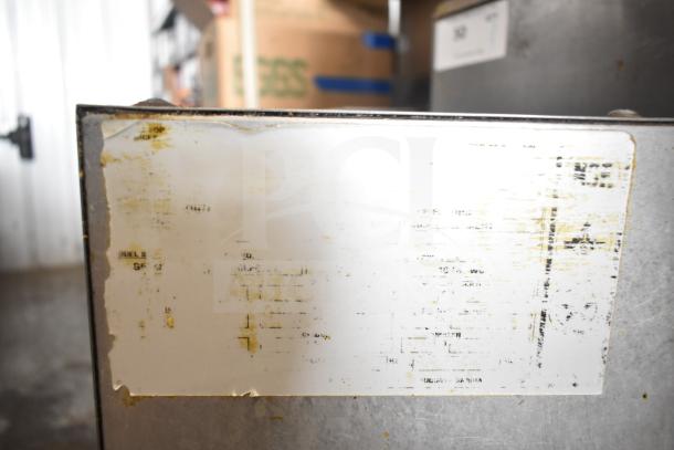 Commercial gas-powered deep fat fryer showing worn labelling. Stainless steel exterior. Suitable for high-volume cooking.