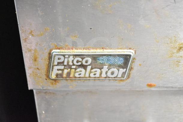 Pitco Frialator plaque on a commercial deep fat fryer, showing minor rust and wear.