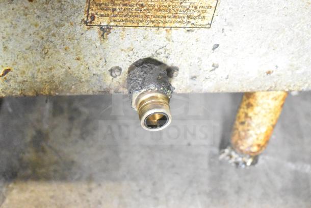 Pitco Frialator commercial gas fryer socket with visible wear. Includes partial view of splash guards and label.