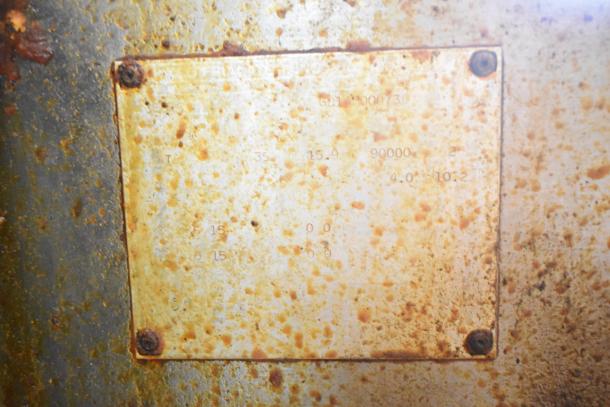 Pitco Frialator commercial gas deep fryer with 90,000 BTU, visible wear and rust. Partial label details technical specs.