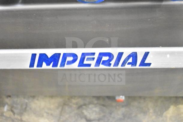 Imperial Commercial Gas 6 Burner Range with oven, over shelf, and backsplash in good condition. Visible "IMPERIAL" branding.