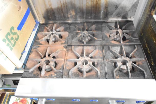Imperial Commercial 6 Burner Gas Range with oven, over shelf, and back splash. Used condition, visible grease stains.