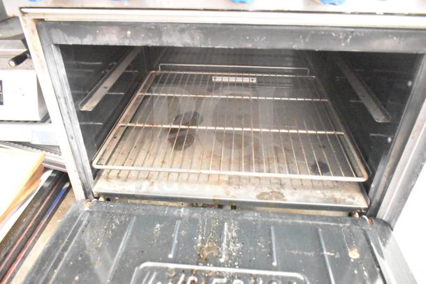 Imperial commercial gas range oven, 6 burners, over shelf, back splash, interior view, used condition.