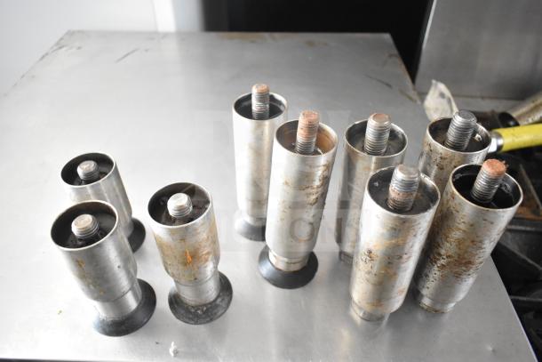 Imperial commercial gas 6-burner range with oven, overshelf, and backsplash. Features visible in image include steel pipe legs. Showing moderate wear.