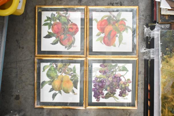 Framed fruit watercolor paintings, four displayed, signed by artist Elizabeth Berry, gold frames, various fruits depicted.