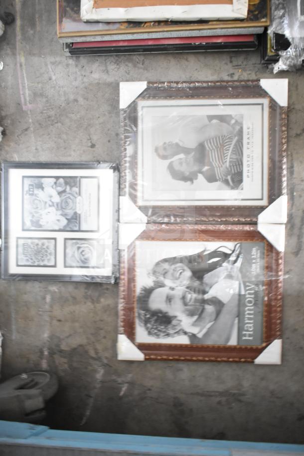 29 various framed pictures, some in ornate brown and black frames, wrapped in protective plastic.