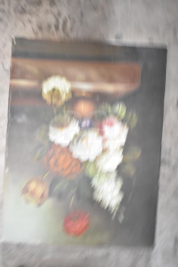 Blurry image of a framed floral painting, with a mix of white, orange, and red flowers, slightly worn condition.