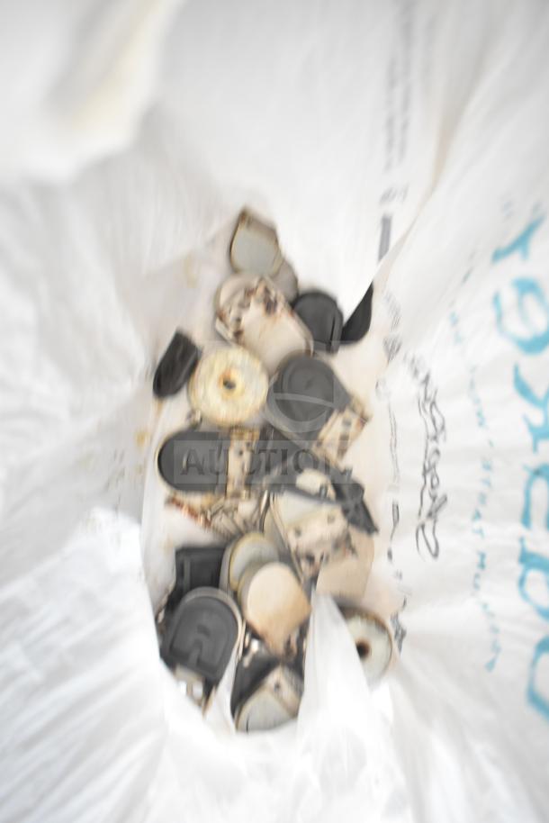 Plastic bag containing mixed metal hardware pieces with some rust, likely unorganized spare parts.