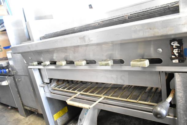 Montague UF-36R commercial 6-burner natural gas range with side charbroiler, under shelves, on casters; well-maintained condition.