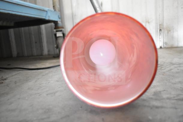 Interior view of a red air pot with a white bulb inside, part of a mixed auction lot with various tools and items.