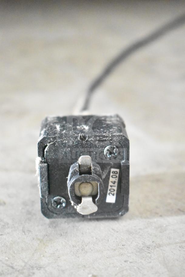 Black electrical switch with visible wear and a "2014.08" label. Part of a mixed items auction lot.