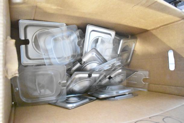 Box with assorted metal lids and trays. Items appear unused, ideal for various culinary or storage applications.