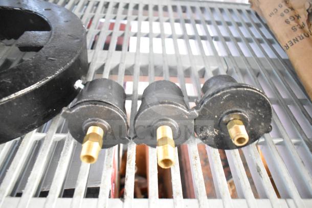 Black ring burner for range, featuring three brass gas nozzles. Ideal for industrial or commercial cooking ranges.