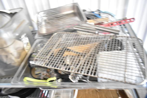 Lot of kitchen items including stainless steel bins, whisks, racks, and cutting board in used condition, on auction.