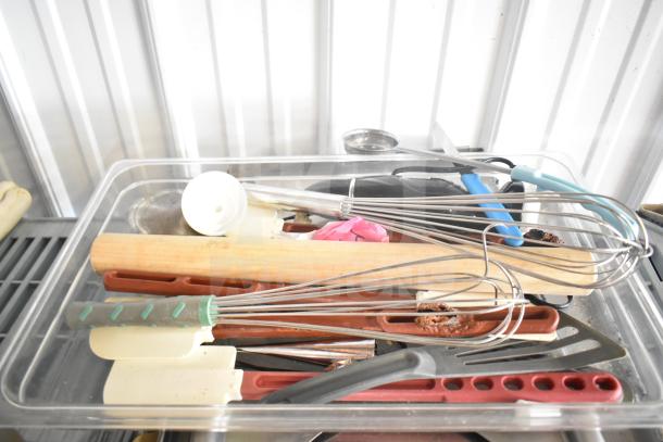 Lot of kitchen items including stainless steel drop-in bins, bowl, cutting board, utensils, and baking sheets.