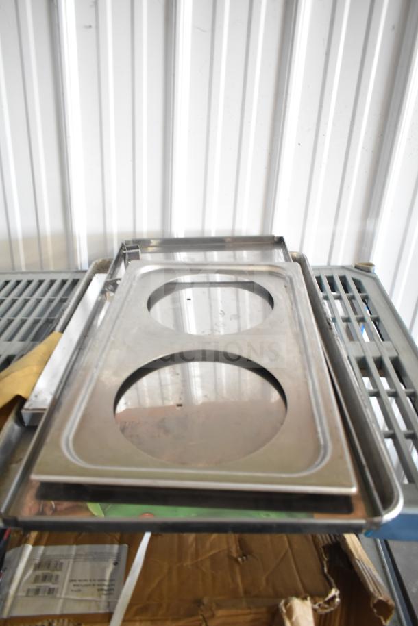 Lot of stainless steel drop-in bins, baking sheets, and assorted kitchen items; visible wear.