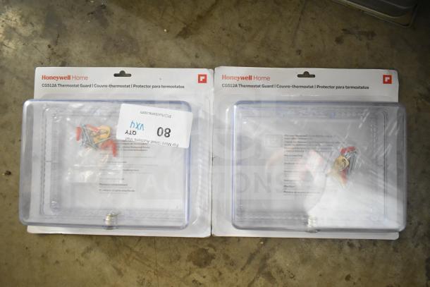 Four items: two Honeywell Home CG512A thermostat guards in packaging, each with installation hardware; two Poly Bar topping rails not pictured.