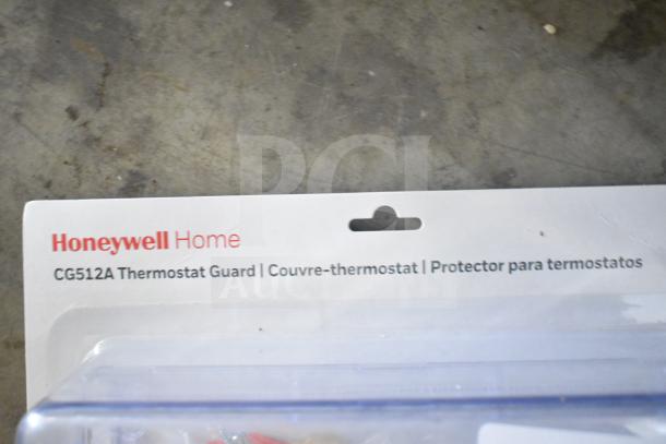 4-pack auction: 2 Honeywell Home CG512A Thermostat Guards and 2 poly bar topping rails, unopened, in original packaging.