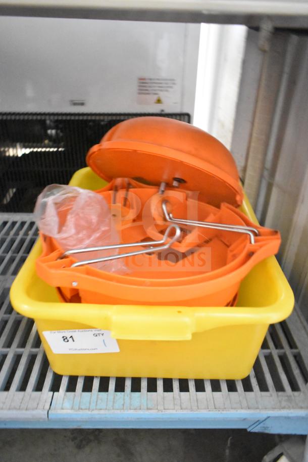 Orange countertop vegetable cutter in a yellow tub; includes metal handles, intact condition, auction label "81, QTY 1.”