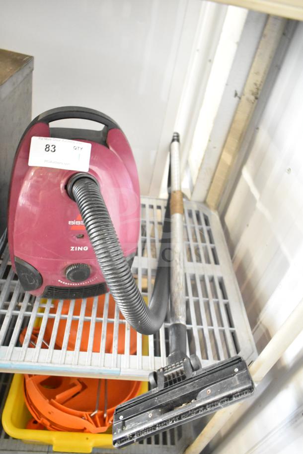 Bissell 4122 Zing Vacuum Cleaner, magenta, 120V, 1 Phase, flexible hose, telescoping wand, auction tag visible.