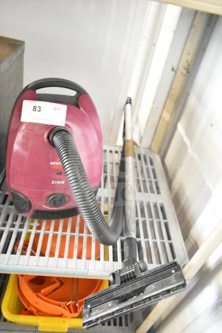 Bissell 4122 Zing Vacuum Cleaner, magenta, 120V, 1 Phase, flexible hose, telescoping wand, auction tag visible.